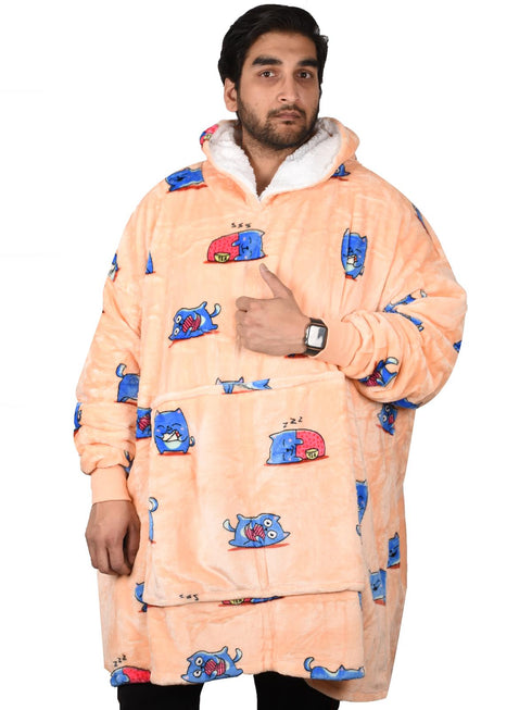 A person wearing a multicolored blanket hoodie with long sleeves, featuring a pocket on the front.